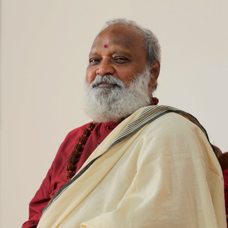 Siddha Guru Pushkara Purvajna, smiling, in a cream shawl